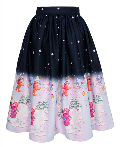 A winter-themed midi skirt with a dark navy top half featuring white star patterns, and a light pink bottom half with a cartoon teddy bear and Christmas tree print. Text below shows style, sizes, fabric, and length details.