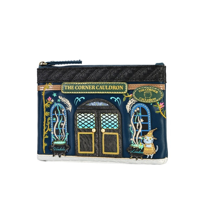 A small zip pouch designed to look like the 'The Corner Cauldron' shop facade from Harry Potter, featuring embroidered details, a cat character, and a dark woven top section, shown on a plain white background.
