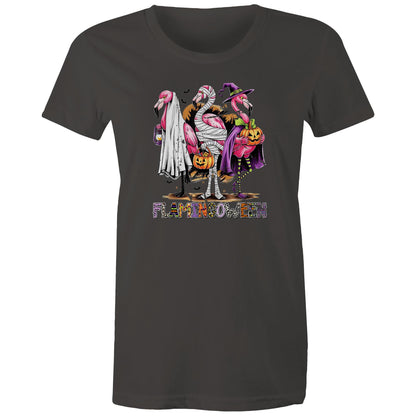 A white t-shirt featuring a colorful graphic of three cartoon flamingos dressed in Halloween costumes. One flamingo wears a white ghost and lantern, another is wrapped in bandages and holds a pumpkin bucket, and the third wears a purple witch hat and cape while holding a jack-o'-lantern.