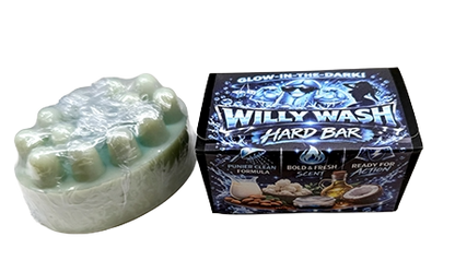 A pale mint green hard bar soap wrapped in clear plastic next to its retail box. The box is black with blue graphics and features the brand name 'Willy Wash' and scent name 'Tribula'.