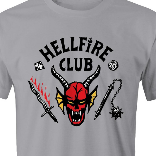 A light gray short-sleeve t-shirt featuring a graphic print on the front with the words 'HELLFIRE CLUB' in black, a red horned devil face, a black sword with red flames, and a black spiked chain.