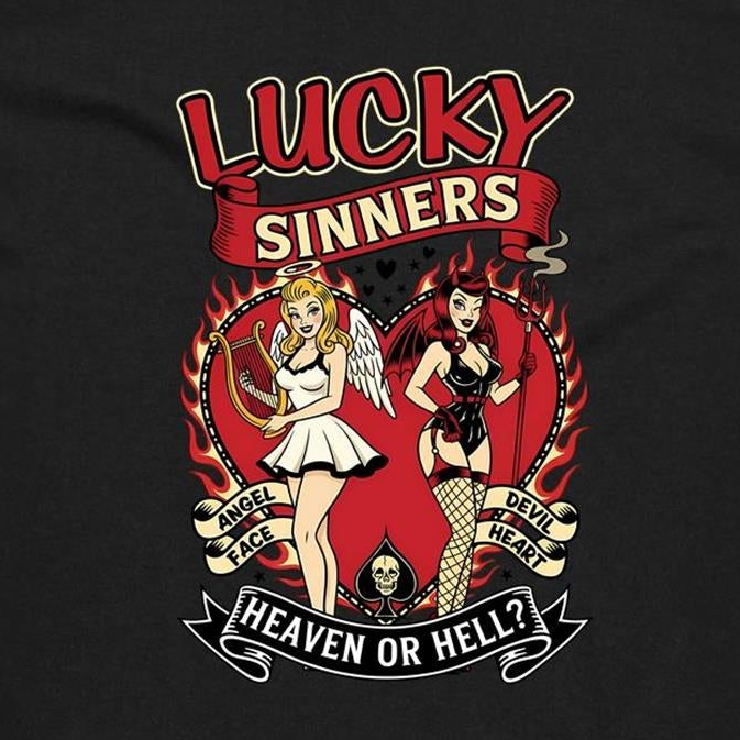 A black graphic t-shirt featuring a retro-style tattoo-style illustration of two pin-up girls, one angel and one devil, with the text 'LUCKY SINNERS' and 'HEAVEN OR HELL?'.