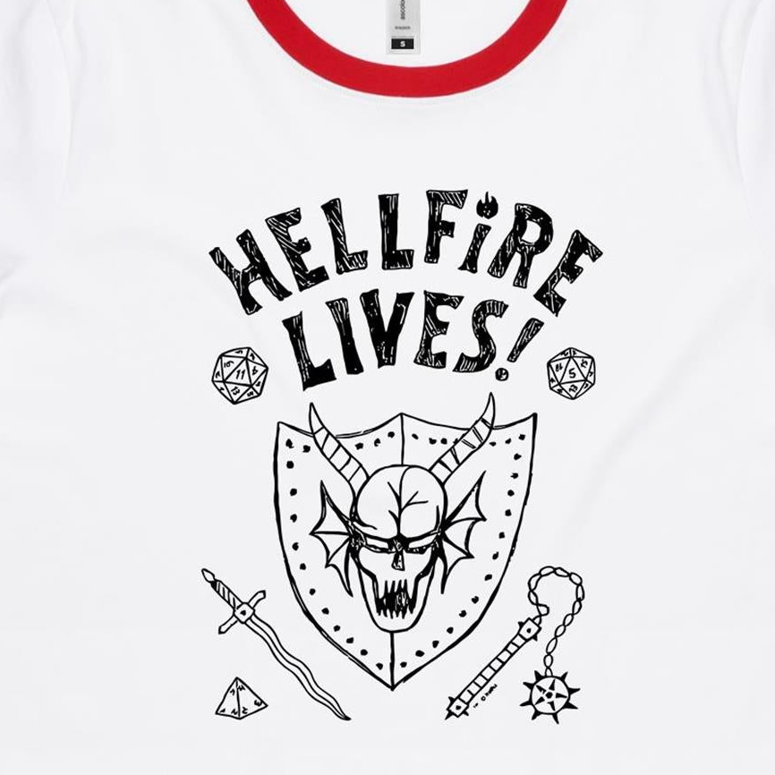 White ringer t-shirt with a red collar trim, featuring a black graphic print of a horned skull on a shield, the text 'HELLFIRE LIVES!', and fantasy-themed icons including dice, a sword, and a mace.