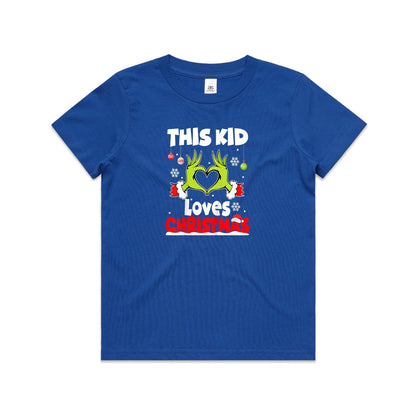 A close-up of a green Christmas t-shirt featuring a graphic of the Grinch's hands forming a heart, with the text 'THIS KID Loves CHRISTMAS' in white and red.