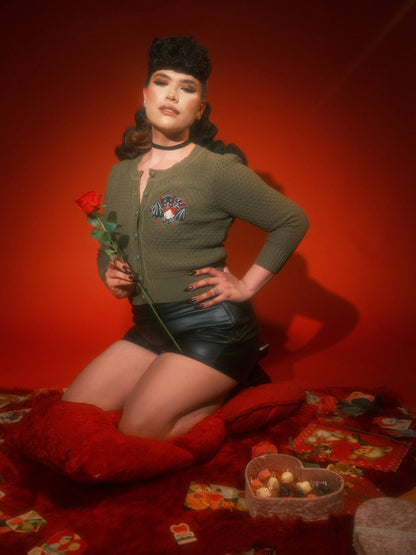 Woman holding a red rose against a red background