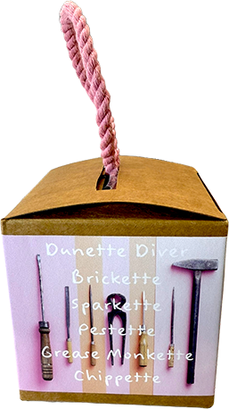 A boxed set of Dunette Diver diving tools with a pink rope handle, shown against a plain white background. The box is tan cardboard with a pink front label listing the tools: Diver, Brickette, Sparkette, Pestette, Grease Monette, and Chippette.