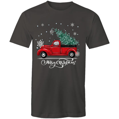 A green crewneck t-shirt featuring a festive graphic of a vintage red pickup truck carrying a Christmas tree, surrounded by white snowflakes and the text 'Merry Christmas' in white script.