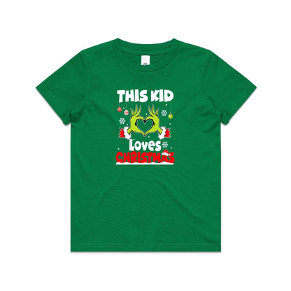 A close-up of a green Christmas t-shirt featuring a graphic of the Grinch's hands forming a heart, with the text 'THIS KID Loves CHRISTMAS' in white and red.