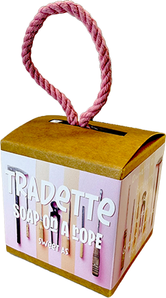 A square cardboard soap-on-a-rope box with a pink rope handle, featuring a pink and white striped front label that reads 'TRADETTTE SOAP ON A ROPE' and 'sweet 16'.
