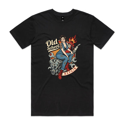 A vintage-style pin-up illustration printed on a white garment, showing a woman in blue overalls and red boots sitting on a motorcycle engine with wrenches, a gas pump, flames, and the words 'Old School' and 'REPAIR'.