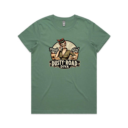 A graphic print on a white background featuring a retro-style pinup illustration of a woman with sunglasses, a red bandana, and an olive green shirt, with the text 'Pinup Girl' and 'Dusty Road Diva'.