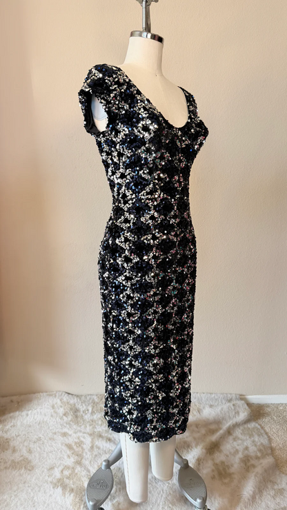 Black floral dress on a mannequin against a beige background