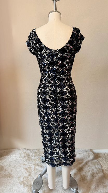 Black floral dress on a mannequin against a plain background