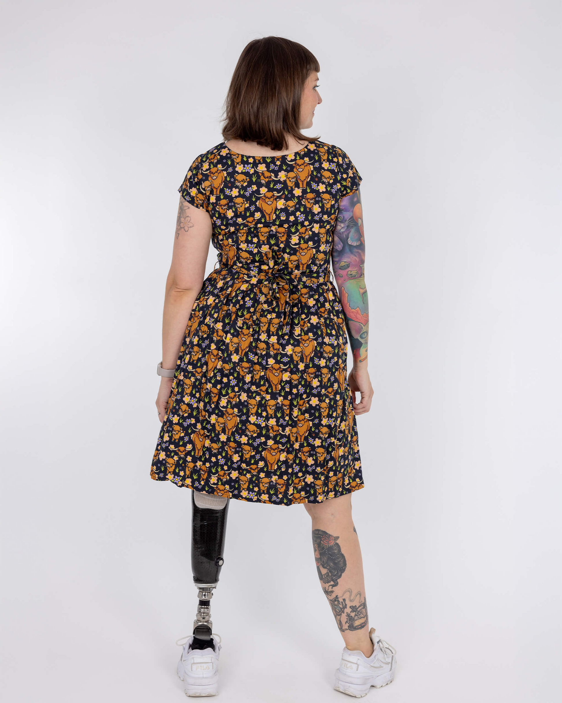 Person wearing a floral dress with a white background