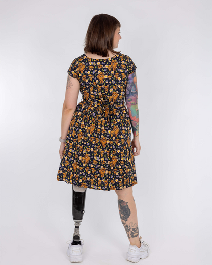Person wearing a floral dress with a white background
