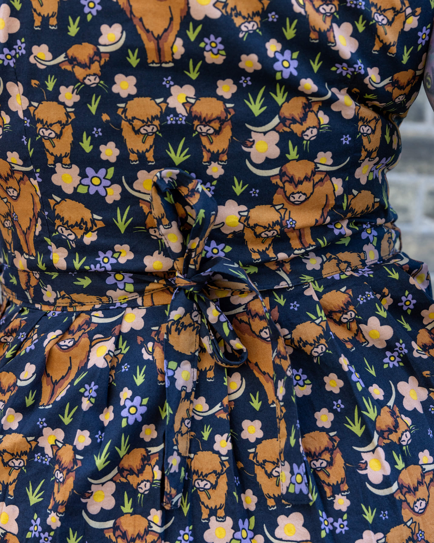Navy blue dress with brown bear and floral pattern