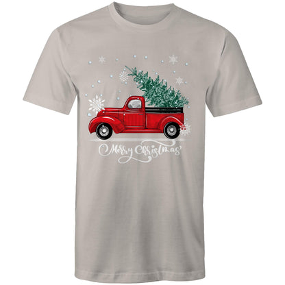 A green crewneck t-shirt featuring a festive graphic of a vintage red pickup truck carrying a Christmas tree, surrounded by white snowflakes and the text 'Merry Christmas' in white script.