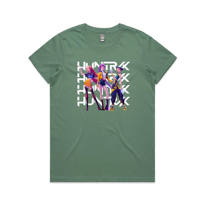 A close-up of a t-shirt featuring a graphic print of three stylized female characters in colorful outfits, overlaid with the word 'HUNTER' repeated vertically in bold white letters.