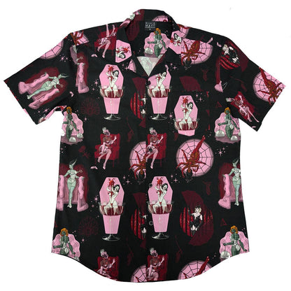 A short-sleeve button-up shirt with a black background and a repeating gothic illustration pattern featuring pink coffins, red spiders, and vintage-style pin-up figures.