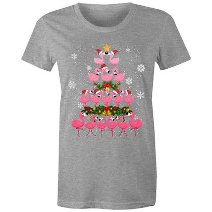 A women's black t-shirt with a printed design of pink flamingos forming a Christmas tree, with snow and Christmas decorations around.