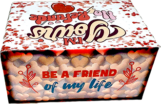 A square gift box filled with small heart-shaped candies, decorated with red hearts and the text 'Be a friend of my life' on the front.