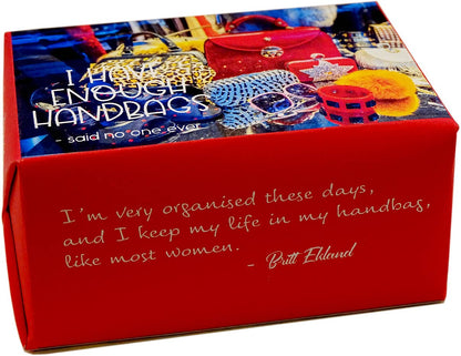 A red rectangular gift box with printed text and a collage of colorful handbags on the lid. The front reads, 'I'm very organised these days, and I keep my life in my handbag, like most women.