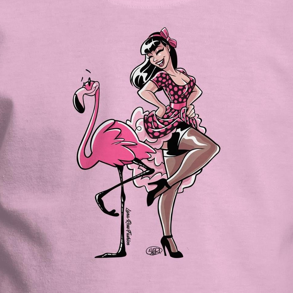 A pink youth t-shirt with a graphic print of a flamingo wearing a tutu and a feather boa, seated on a chair.