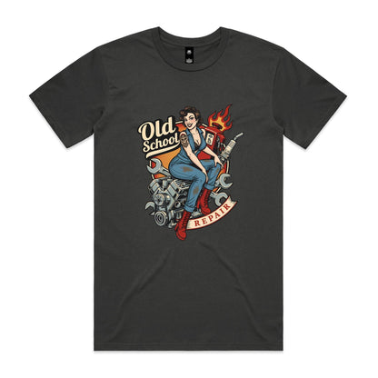 A vintage-style pin-up illustration printed on a white garment, showing a woman in blue overalls and red boots sitting on a motorcycle engine with wrenches, a gas pump, flames, and the words 'Old School' and 'REPAIR'.
