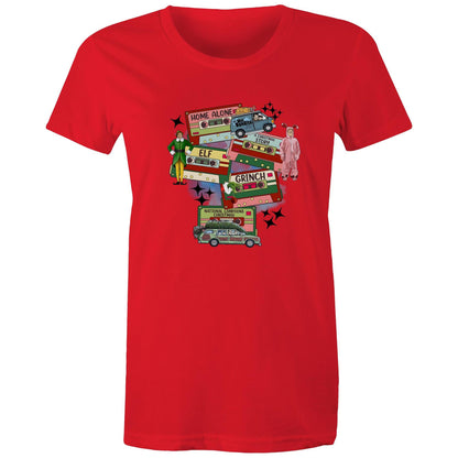 A graphic print on a light beige fabric featuring retro cassette tapes labeled 'Home Alone', 'Elf', 'The Grinch', 'National Lampoons Christmas', and 'A Christmas Story', with illustrated characters and black starbursts.
