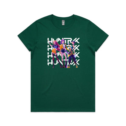 A close-up of a t-shirt featuring a graphic print of three stylized female characters in colorful outfits, overlaid with the word 'HUNTER' repeated vertically in bold white letters.
