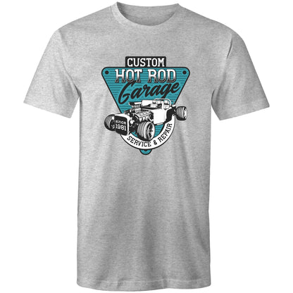 t-shirt featuring a large graphic print on the chest. The graphic is a teal and black triangular badge with the text 'CUSTOM HOT ROD Garage' and 'SERVICE & REPAIR since 1981', surrounding an illustration of a classic hot rod car with an exposed engine elements