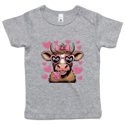 Infant pink t-shirt with a graphic of a cow with hearts and sunglasses.