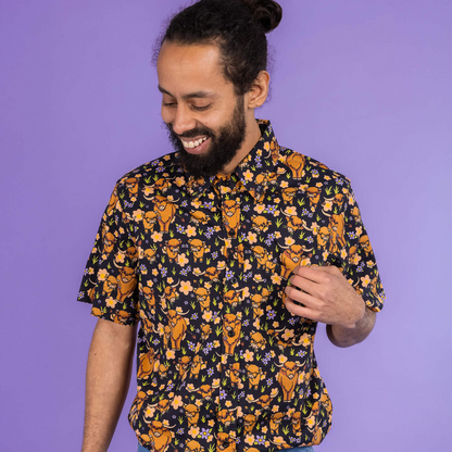 Man wearing a patterned shirt with a purple background