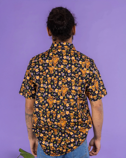Person wearing a patterned shirt with a purple background