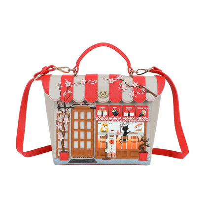 Handbag with a design of a building and cherry blossoms on a white background