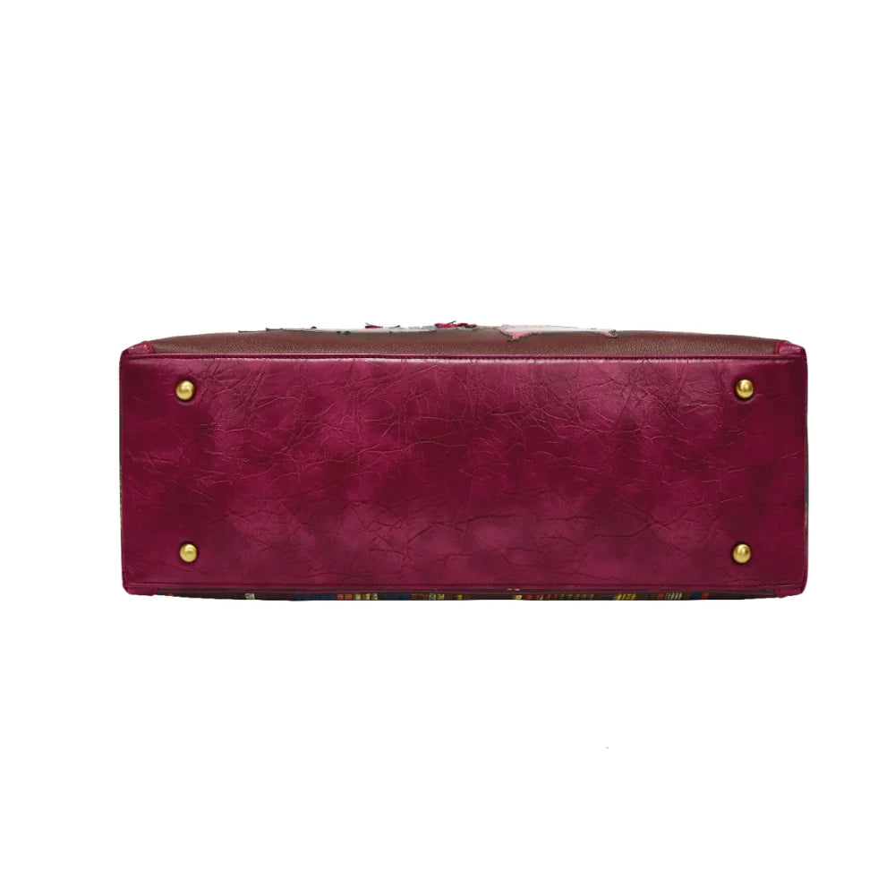 Maroon leather handbag with gold studs on a white background