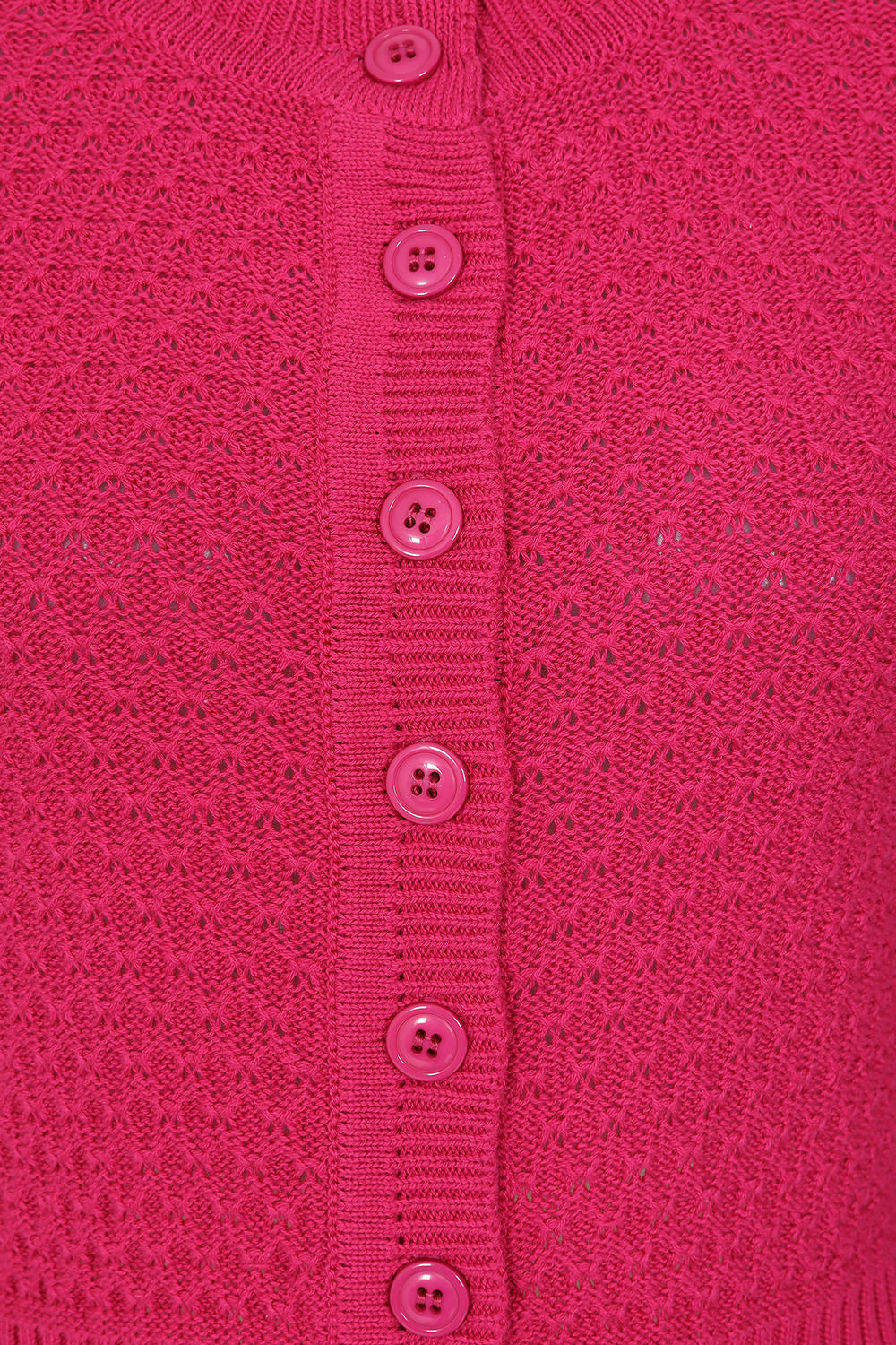 Close-up of a pink textured garment with button details