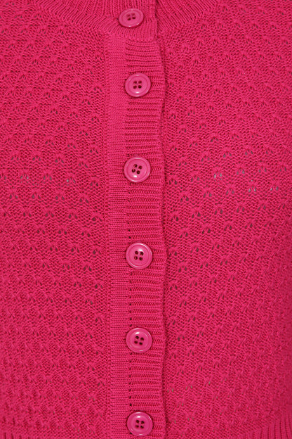 Close-up of a pink textured garment with button details