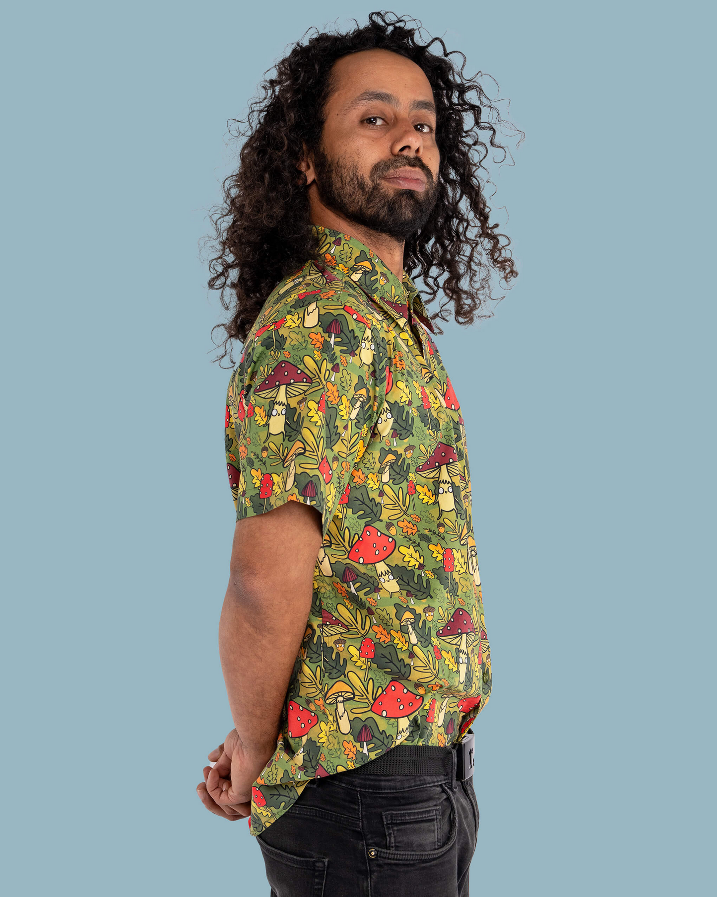 Man wearing a patterned shirt with a blue background
