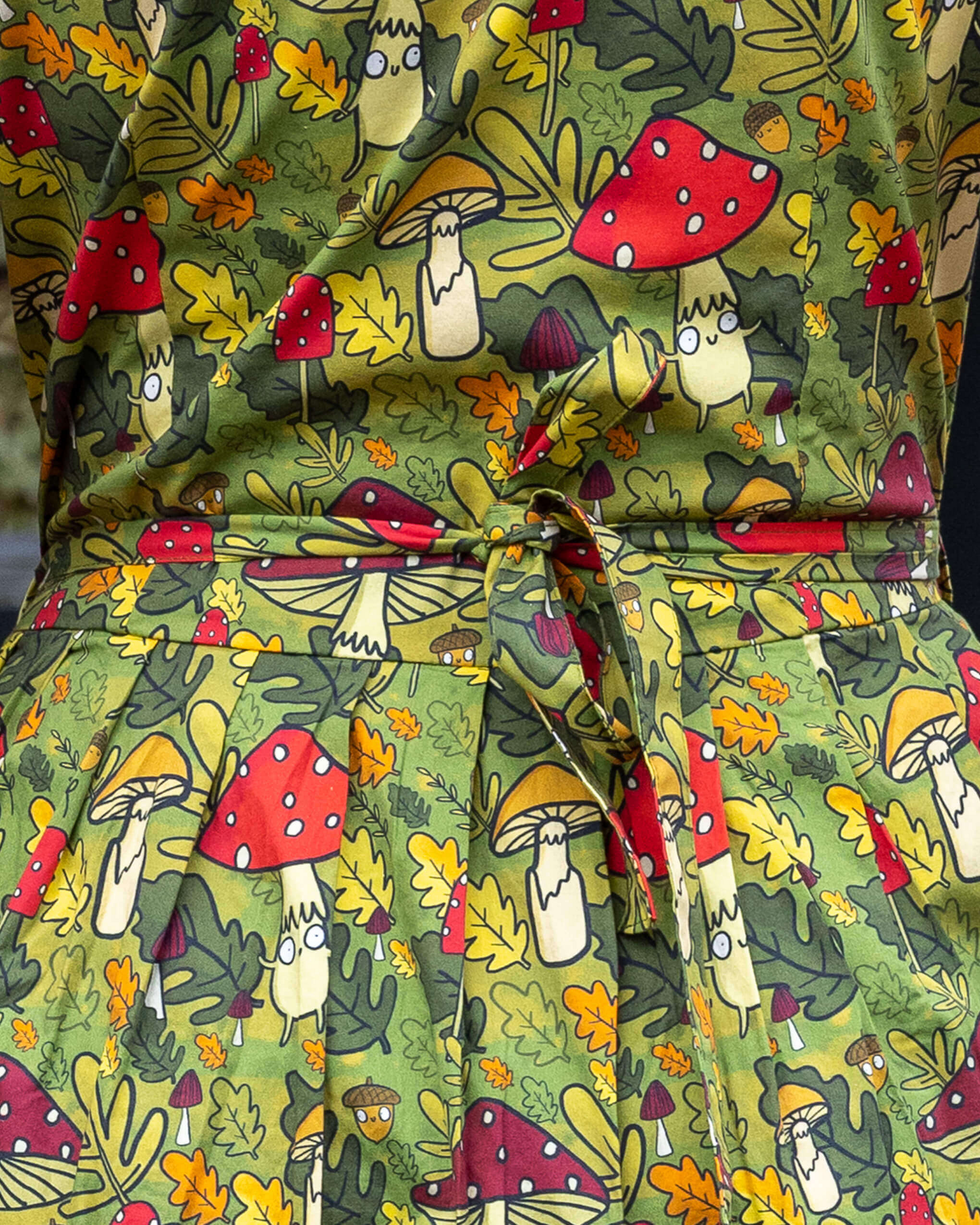 Green fabric with cartoon mushroom pattern