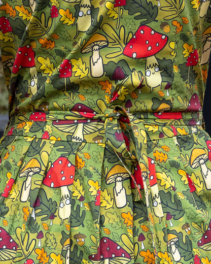 Green fabric with cartoon mushroom pattern