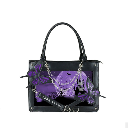 Black handbag with purple butterfly design and castle scene on a white background