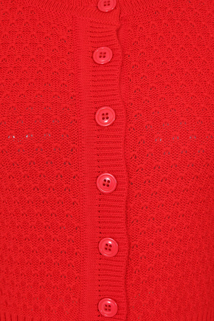 Close-up of a red textured fabric with buttons