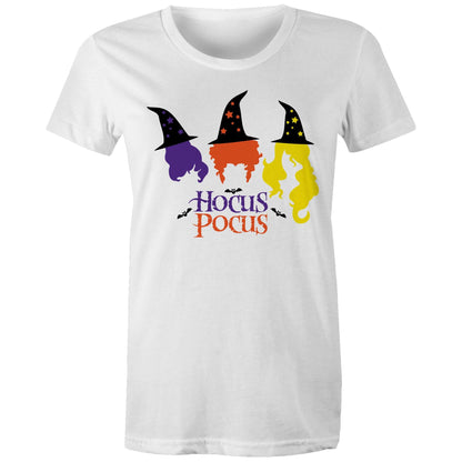 A close-up of a white fabric surface featuring a colorful Halloween graphic with three witch hats and flowing hair in purple, orange, and yellow, plus the words 'Hocus Pocus' and small bat silhouettes.